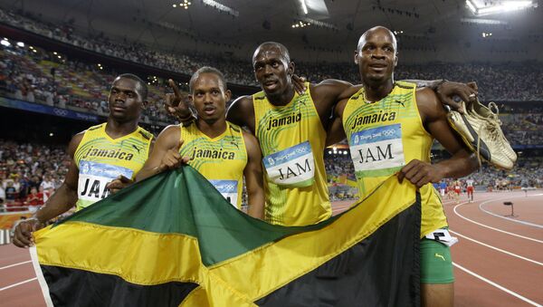 Jamaica's gold medal winning relay team, Usain Bolt, 2nd right, Michael Frater, 2nd left, Asafa Powell, right, and Nesta Carter celebrate after the men's 4x100-meter relay final during the athletics competitions in the National Stadium at the Beijing 2008 Olympics in Beijing, Friday, Aug. 22, 2008 - Sputnik International
