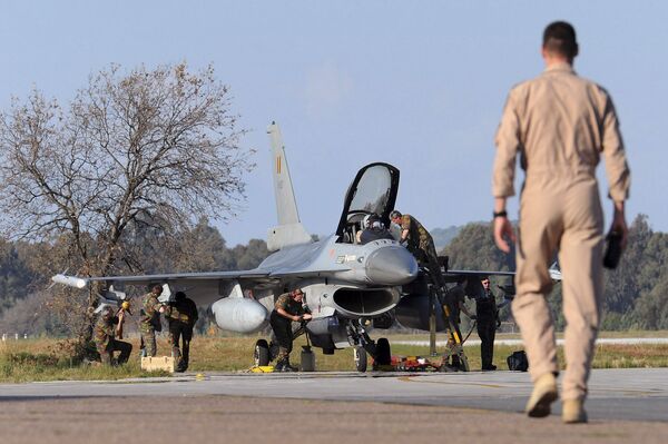 A Belgian pilot walks toward his F-16 fighter jet at Araxos airport in Kato Ahaia, Greece on Monday, March 28, 2011.  - Sputnik International