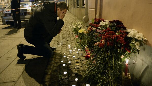 A man reacts as he places flowers in memory of victims of the blast in the Saint Petersburg metro outside Technological Institute station on April 3, 2017 - Sputnik International