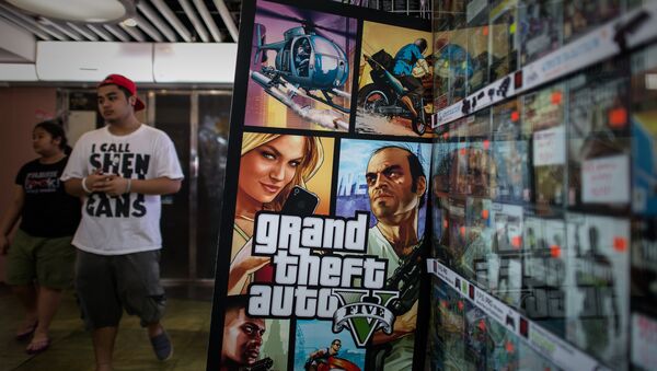 A man walks past a billboard of the Grand Theft Auto V video game in Hong Kong on September 17, 2013 - Sputnik International