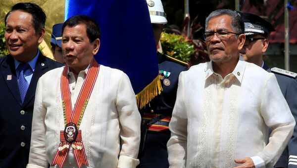 Philippine President Rodrigo Duterte (C) walks with Department of Interior and Local Government Secretary, Mr Ismael Sueno, during the Philippine National Police Academy (PNPA) graduation in Camp Castaneda, Silang town in Cavite city, south of Manila, Philippines March 24, 2017. Picture taken March 24, 2017 - Sputnik International
