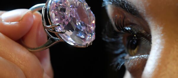A model poses with a 59.60-carat mixed cut diamond known as The Pink Star which sold for $71.2 million. A model poses with a 59.60-carat mixed cut diamond known as The Pink Star which sold for $71.2 million. - Sputnik International