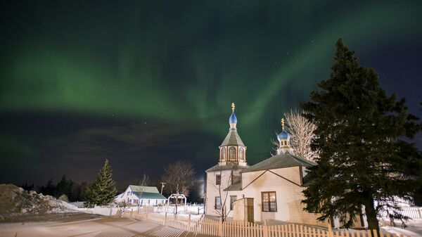 The aurora borealis, or northern lights, fill the sky early Sunday, March 17, 2013, above the Holy Assumption of the Virgin Mary Russian Orthodox church in Kenai, Alaska. The bright display at times filled the sky. - Sputnik International