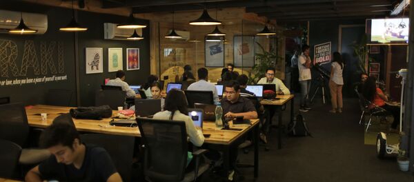 Young Indian entrepreneurs and freelancers work at Innov8, a lax co-working space in New Delhi, India. (File) Young Indian entrepreneurs and freelancers work at Innov8, a lax co-working space in New Delhi, India. (File) - Sputnik International