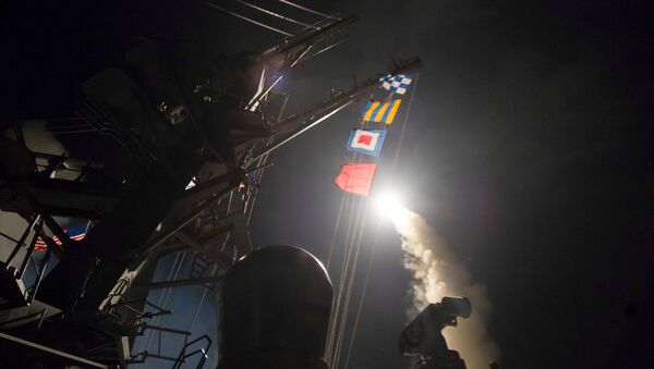 U.S. Navy guided-missile destroyer USS Ross (DDG 71) fires a tomahawk land attack missile in Mediterranean Sea which U.S. Defense Department said was a part of cruise missile strike against Syria on April 7, 2017. - Sputnik International