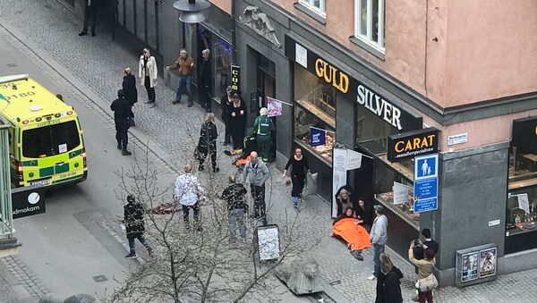 Ambulance in a street near the site were a truck was driven into a crowd in central Stockholm, Sweden - Sputnik International