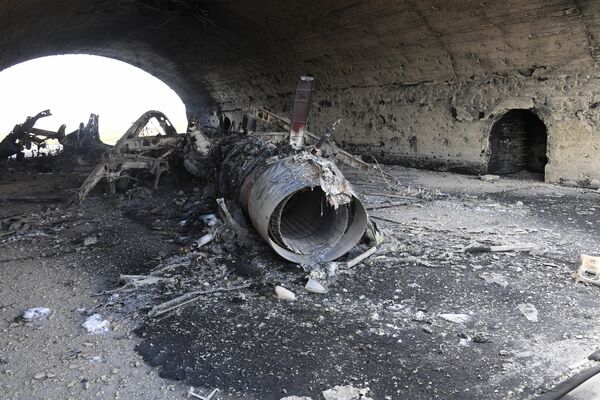 The body of a plane burned as a result of the US missile strike on an air base in Syria The body of a plane burned as a result of the US missile strike on an air base in Syria - Sputnik International