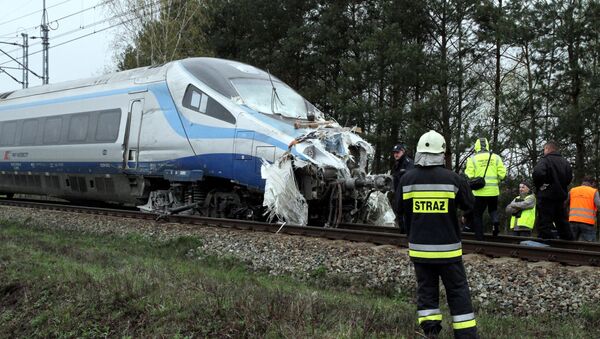 Emergency services work at the scene where a collision of a train and a truck in Schodnia, south Poland - Sputnik International
