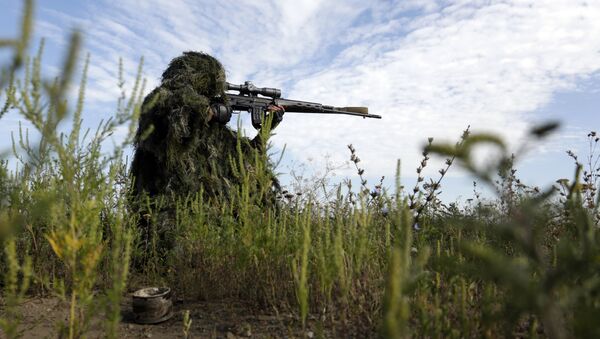 A Ukrainian sniper holds on the position of Ukrainian forces on frontline in the Lugansk region on August 27, 2015 - Sputnik International