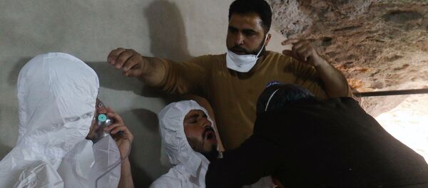A man breathes through an oxygen mask as another one receives treatments, after what rescue workers described as a suspected gas attack in the town of Khan Sheikhoun in Idlib, Syria April 4, 2017 - Sputnik International