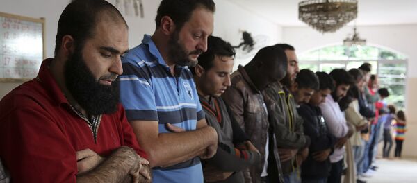 In this May 15, 2015 photo, Syrian refugee Abdulhannan Mouhammed, left, attends Friday prayer at a mosque in Sao Paulo, Brazil - Sputnik International