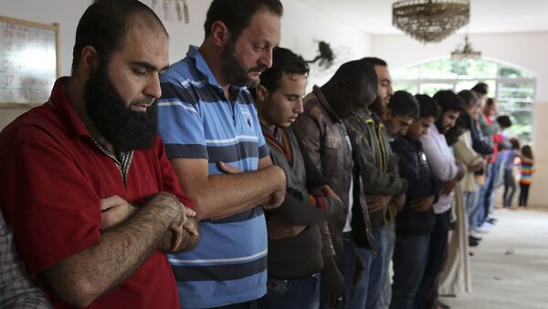In this May 15, 2015 photo, Syrian refugee Abdulhannan Mouhammed, left, attends Friday prayer at a mosque in Sao Paulo, Brazil - Sputnik International