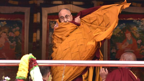 Exiled Tibetan spiritual leader the Dalai Lama adjusts his shawl as he came to deliver his religious teaching at Yiga Choezin ground at in Tawang District near India-china border in India's north-eastern state of Arunachal Pradesh state, on April 8, 2017 - Sputnik International