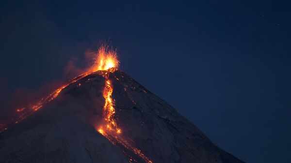 Volcan de Fuego, or Volcano of Fire, spews hot molten lava from its crater in San Juan Alotenango, Guatemala, Wednesday, July 1, 2015. - Sputnik International