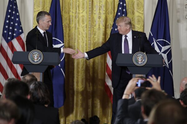 President Donald Trump reaches to shake hands with NATO Secretary General Jens Stoltenberg during a news conference in the East Room of the White House, Wednesday, April 12, 2017, in Washington.  - Sputnik International