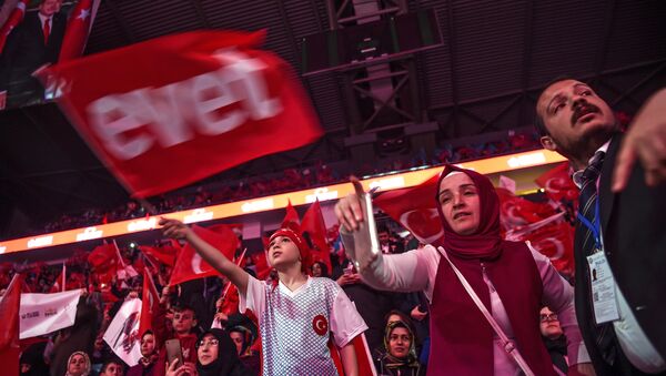 Supporters wave Turkey's national flags and a flag reading Yes in Turkish (L) during a campaign rally of Turkey's president on April 12, 2017 during a 15 July Martyrs meeting and a campaign rally for the yes vote in a constitutional referendum in Istanbul - Sputnik International