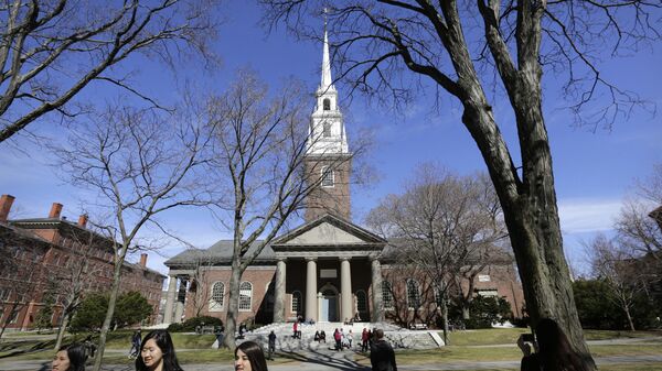 In this Sunday, March 13, 2016, photo people walk near Memorial Church, behind, on the campus of Harvard University, in Cambridge, Mass. Amid scrutiny from Congress and campus activists, colleges across the country are under growing pressure to reveal the financial investments made using their endowments. - Sputnik International