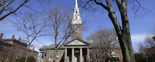 In this Sunday, March 13, 2016, photo people walk near Memorial Church, behind, on the campus of Harvard University, in Cambridge, Mass. Amid scrutiny from Congress and campus activists, colleges across the country are under growing pressure to reveal the financial investments made using their endowments. - Sputnik International