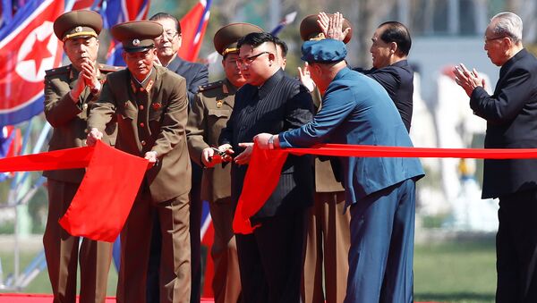 North Korean leader Kim Jong Un cuts the ribbon during an opening ceremony of a newly constructed residential complex in Ryomyong street in Pyongyang, North Korea April 13, 2017. - Sputnik International