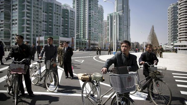 North Korean men push their bicycles along Ryomyong residential area, a collection of more than a dozen apartment buildings, on Thursday, April 13, 2017, in Pyongyang, North Korea. - Sputnik International