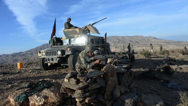 In this photograph taken on December 3, 2016, Afghan security forces take positions following an operation against DAESH militants in Pachir Wa Agam district of Nangarhar province. - Sputnik International