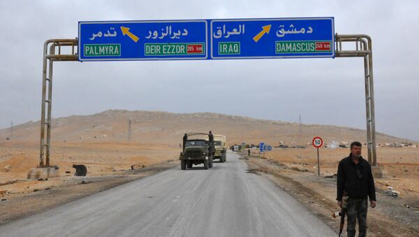 A picture taken on March 2, 2017, shows a sign displaying the routes to Palmyra-Deir Ezzor and Damascus-Iraq - Sputnik International