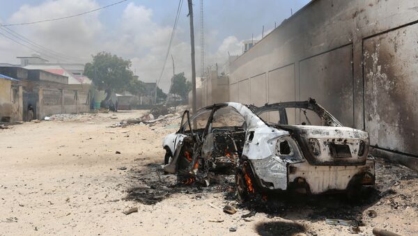 A burning car is seen after a clash among gunmen and security members, in Madina district of Somalia's capital Mogadishu, April 16, 2017 - Sputnik International