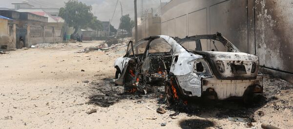 A burning car is seen after a clash among gunmen and security members, in Madina district of Somalia's capital Mogadishu, April 16, 2017 A burning car is seen after a clash among gunmen and security members, in Madina district of Somalia's capital Mogadishu, April 16, 2017 - Sputnik International