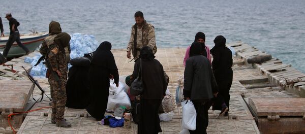 Syrian Democratic Forces (SDF) fighters relocate people that fled from Raqqa city on the bank of the Euphrates river, west of Raqqa city, Syria April 8, 2017 Syrian Democratic Forces (SDF) fighters relocate people that fled from Raqqa city on the bank of the Euphrates river, west of Raqqa city, Syria April 8, 2017 - Sputnik International
