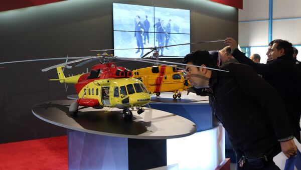 An Iranian man looks at model of a helicopter at the stand of the Russian company Rostec on December 22, 2015 during the Russia National Industrial Exhibition in Tehran - Sputnik International