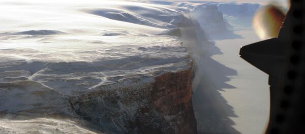 Snow from the neighboring plateau falling onto the windswept east wall of the Petermann Glacier. Snow from the neighboring plateau falling onto the windswept east wall of the Petermann Glacier. - Sputnik International