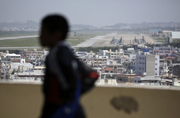 A child looks at the U.S. Marine Corps Futenma Air Station and the surrounding area from an observation deck at a park in Ginowan, Okinawa Prefecture on southern Japan. A child looks at the U.S. Marine Corps Futenma Air Station and the surrounding area from an observation deck at a park in Ginowan, Okinawa Prefecture on southern Japan. - Sputnik International