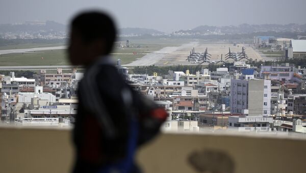 A child looks at the U.S. Marine Corps Futenma Air Station and the surrounding area from an observation deck at a park in Ginowan, Okinawa Prefecture on southern Japan. - Sputnik International