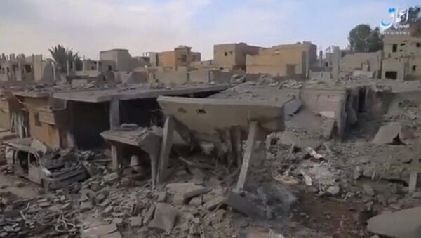 A still image taken from a video released on the internet by Islamic State-affiliated Amaq News Agency, on April 18, 2017, purports to show the aftermath, said to be in al-Bukamal town, in Deir al-Zor province, after air strikes thought to have been directed by planes from a U.S.-led military coalition, Syria - Sputnik International