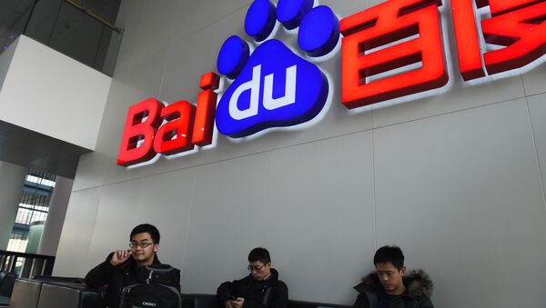 People sit below a Baidu logo at the Baidu headquarters in Beijing on December 17, 2014. - Sputnik International