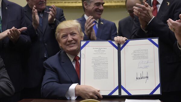 President Donald Trump hold up the Veterans Choice Program Extension and Improvement Act that he signed, Wednesday, April 19, 2017, in the Roosevelt Room of the White House in Washington - Sputnik International