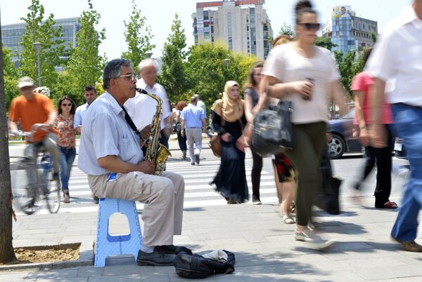 A man plays the saxophone on a street in downtown Tirana, on June 12, 2015 A man plays the saxophone on a street in downtown Tirana, on June 12, 2015 - Sputnik International