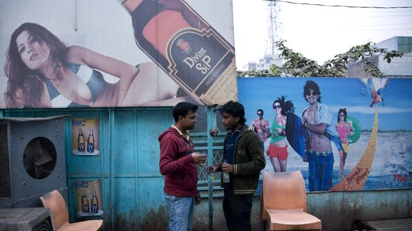 Two Indian men share a moment as they drink outside a state-sanctioned liquor shop in Allahabad, India - Sputnik International