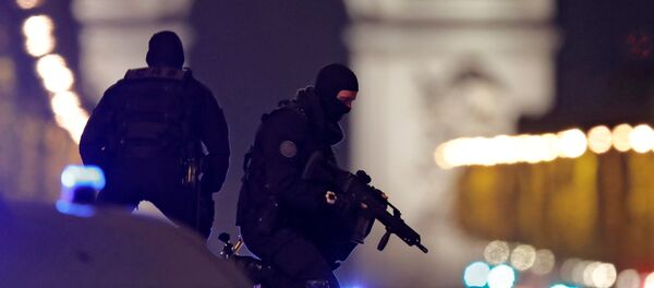 Masked police stand on top of their vehicle on the Champs Elysees Avenue after a policeman was killed and two others were wounded in a shooting incident in Paris, France, April 20, 2017. Masked police stand on top of their vehicle on the Champs Elysees Avenue after a policeman was killed and two others were wounded in a shooting incident in Paris, France, April 20, 2017. - Sputnik International