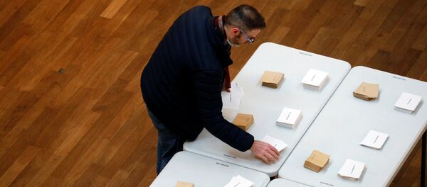 A man choose his ballots before voting in the first round of 2017 French presidential election at a polling station in Lyon, France, April 23, 2017. A man choose his ballots before voting in the first round of 2017 French presidential election at a polling station in Lyon, France, April 23, 2017. - Sputnik International