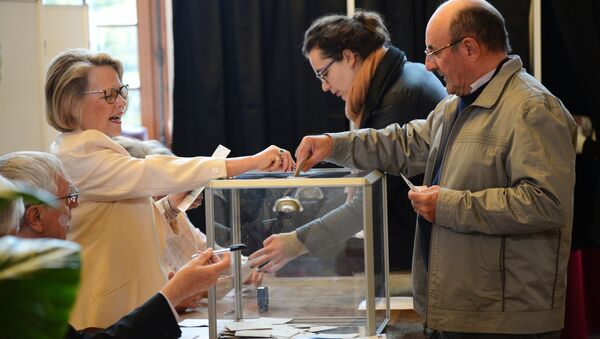 People vote at a polling station in Paris in the first round of the French presidential election. - Sputnik International