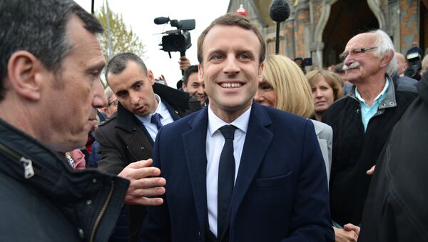 Emmanuel Macron, leader of En Marche! movement, center, is seen here in Le Touquet-Paris-Plage in the Pas-de-Calais department during the first round of the French presidential elections. - Sputnik International