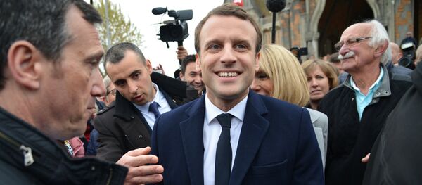 Emmanuel Macron, leader of En Marche! movement, center, is seen here in Le Touquet-Paris-Plage in the Pas-de-Calais department during the first round of the French presidential elections. - Sputnik International