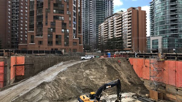 Construction equipment is parked at the bottom of a pit on the site of a new condominium complex off Redpath Avenue in Toronto, Ontario, Canada April 1, 2017 - Sputnik International