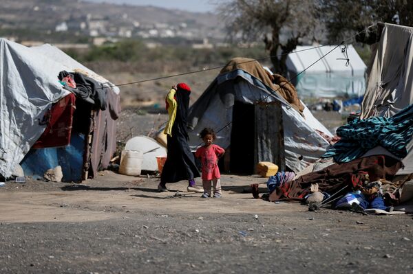 A woman walks past a child at a camp for people displaced by the war, near Sanaa, Yemen April 25, 2017 A woman walks past a child at a camp for people displaced by the war, near Sanaa, Yemen April 25, 2017 - Sputnik International