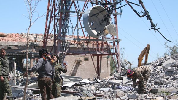 Fighters from the Kurdish People's Protection Units (YPG) inspect the damage at their headquarters after it was hit by Turkish airstrikes in Mount Karachok near Malikiya, Syria April 25, 2017 - Sputnik International