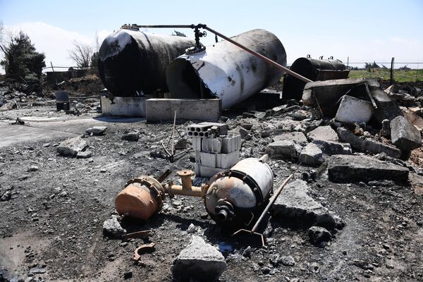 Aftermath of US missile attack on Ash Sha'irat airbase in Syria. File photo Aftermath of US missile attack on Ash Sha'irat airbase in Syria. File photo - Sputnik International