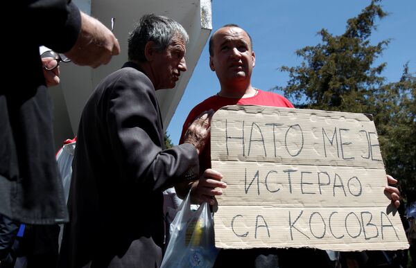 A protester holds a banner that reads NATO forced me out of Kosovo after a protest described as a parallel parliament, ahead of April 28's parliament vote to ratify the Montenegro's NATO membership, in the village of Murino, Montenegro, April 26, 2017 A protester holds a banner that reads NATO forced me out of Kosovo after a protest described as a parallel parliament, ahead of April 28's parliament vote to ratify the Montenegro's NATO membership, in the village of Murino, Montenegro, April 26, 2017 - Sputnik International