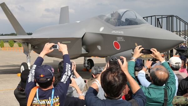Visitors photograph a mock-up of the F-35 fighter jet displayed at the annual Self-Defense Forces Commencement of Air Review at Hyakuri Air Base, north of Tokyo, Sunday, Oct. 26, 2014 - Sputnik International