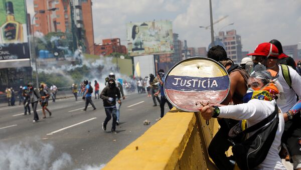 Opposition supporters use a shield reading Justice as they clash with security forces during a rally against Venezuela's President Nicolas Maduro in Caracas, Venezuela April 26, 2017 - Sputnik International